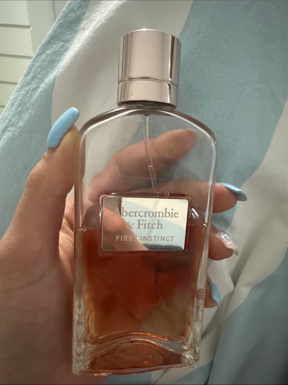 Abercrombie & Fitch First Instinct - Rose Gold Cap with Amber Liquid